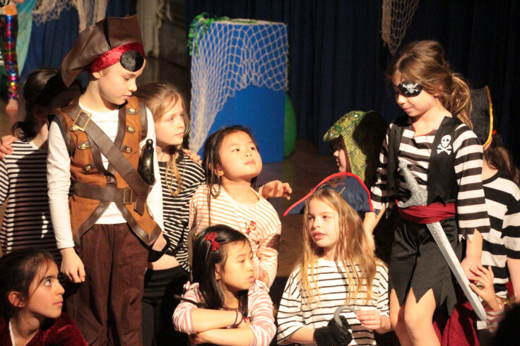 Year 3 girls dressed as pirates for their performance of 'Pirates Versus Mermaids'.