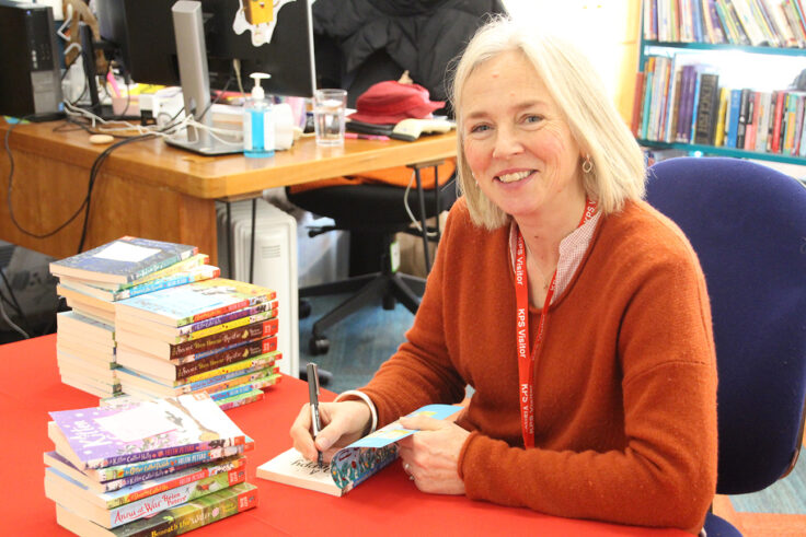 Helen Peter signing books in the library,