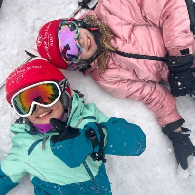 Ken Prep girls lying in the snow on ski trip.
