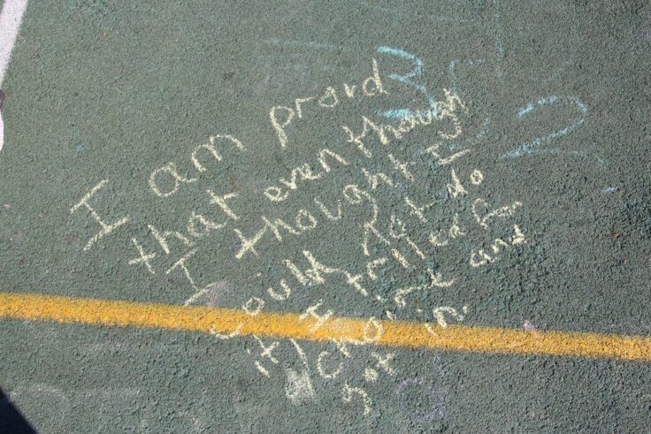 Writing on the playground that reads 'I am proud that even though I though I could not do it, I tried for choir and I got in.'